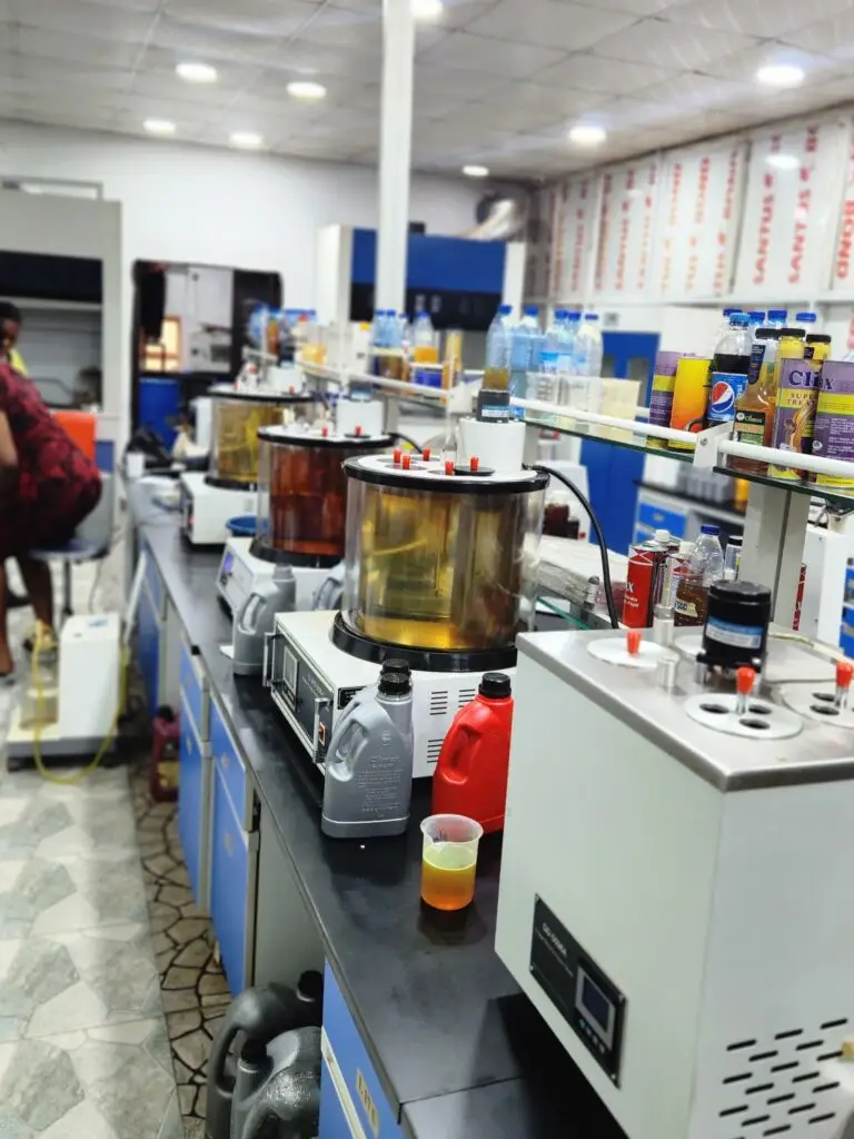 A professional Nigerian technician in a clean, modern Climax Lubricants laboratory, surrounded by scientific equipment.